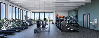 a gym filled with cardio equipment and windows